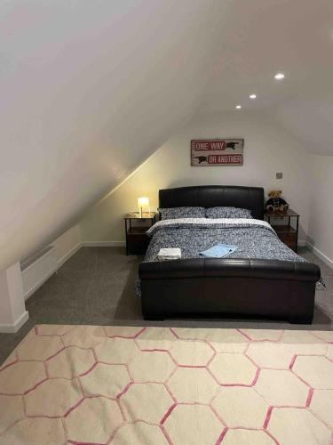 a bedroom with a large bed in a attic at Careful Cottage in Crediton