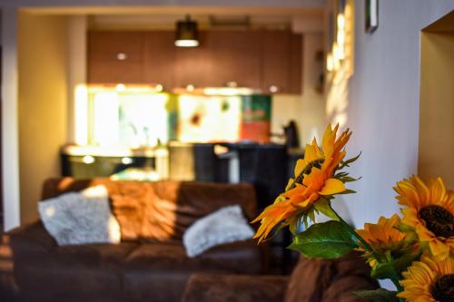 a living room with a couch and a vase of flowers at EXECUTIVE Flat Two Rooms by CHR Luxury Property in Bucharest