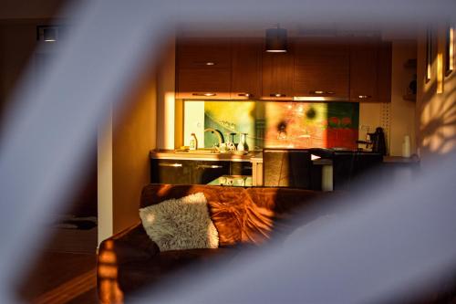 a living room with a couch and a kitchen at EXECUTIVE Flat Two Rooms by CHR Luxury Property in Bucharest