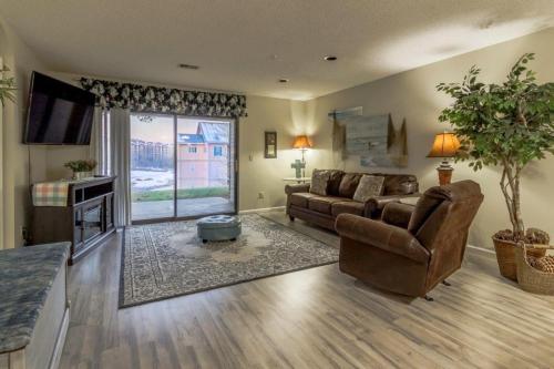 a living room with a couch and a television at Branson Condo on Thousand Hills Golf Course with Indoor Pool and Hot Tub in Branson