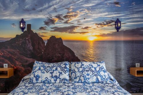 a bedroom with a bed with a view of the ocean at Boutique Hotel El Olivar in Mojácar