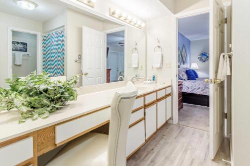 a bathroom with a sink and a large mirror at Branson Condo on Thousand Hills Golf Course with Indoor Pool and Hot Tub in Branson