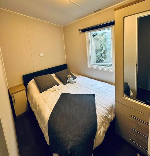 une petite chambre avec un lit avec un ours en peluche dessus dans l'établissement Bungalow accueillant à Saint-Jean-de-Monts avec piscine, à Saint-Jean-de-Monts