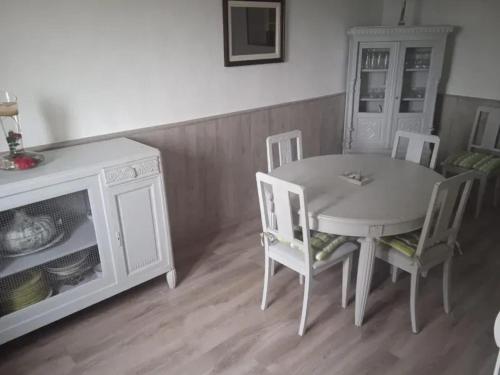 a dining room with a table and chairs and a fireplace at Maison conviviale près de Charron avec jardin, 100 m² in Charron