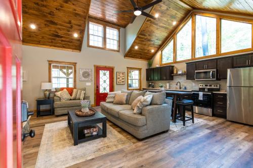 a living room with a couch and a kitchen at Dreamscape in Rogers