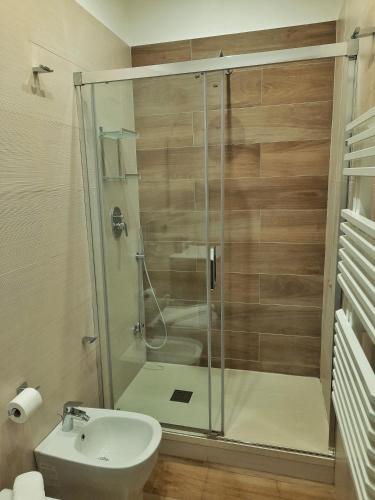 a bathroom with a shower and a toilet and a sink at B&B Il Ritratto in Salerno