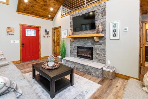 a living room with a fireplace and a red door at Dreamscape in Rogers