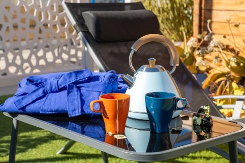 a table with a tea kettle and two cups on it at Boutique Hotel El Olivar in Mojácar