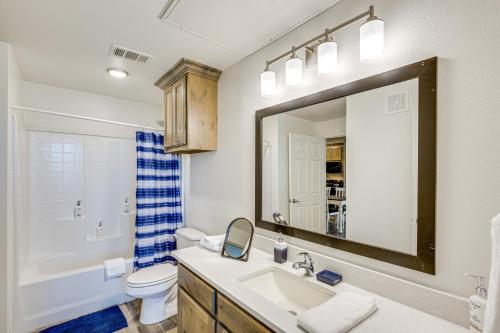 a bathroom with a sink and a toilet and a mirror at Close to Lakes, Parks and Winery Bonham Apt in Bonham
