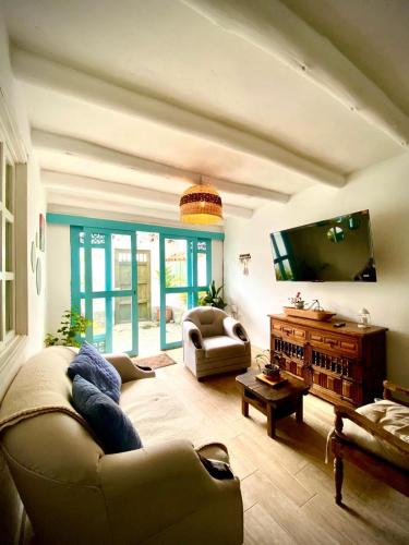 a living room with a couch and a tv at Clareman in Villa de Leyva