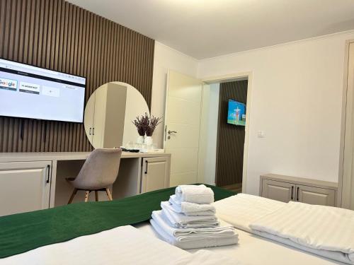 a hotel room with a bed with towels on it at Pensiune cu restaurant Bigfast in Luduş