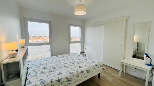 En eller flere senge i et værelse på Le Lumina du centre bourg