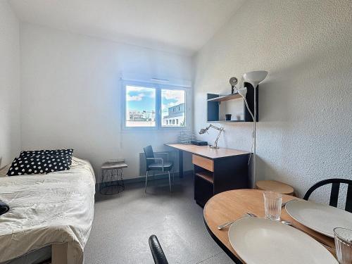 une chambre avec un lit, un bureau et une table dans l'établissement Le Central FAC, Charmant studio à Montpellier, à Montpellier