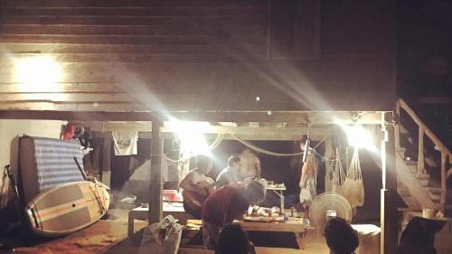 a group of people working in a workshop at night at Kom buds garden in Ko Yao Noi