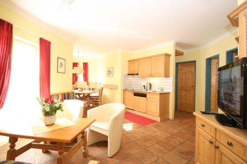 a living room with a kitchen and a dining room at Gästehaus Katharina in Schladming
