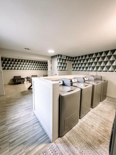 a waiting room with a row of silver appliances at Downtown OS 2bed 1 bath with pool and close to the beach in Ocean Springs