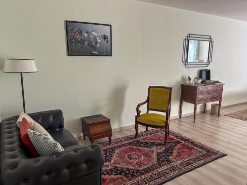a living room with a couch and a chair at Maison Belles Pierres in Montagny-lès-Beaune
