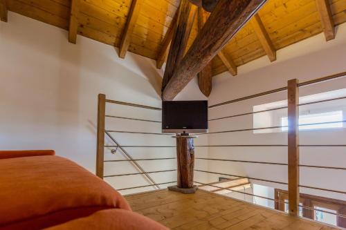 a bedroom with a bed and a tv on the wall at La Villa vacation home Lake Como in Como