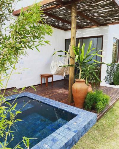 a swimming pool in the backyard of a house at Vila de Charme in São Miguel do Gostoso
