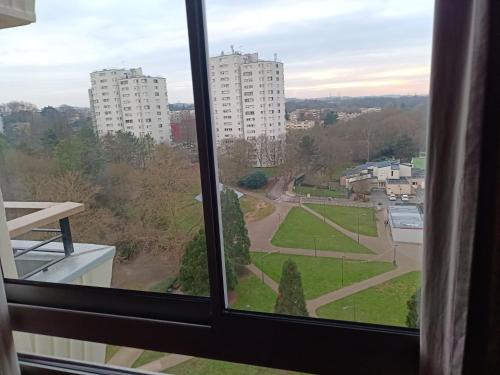 une fenêtre avec vue sur un parc dans l'établissement Chambre chez l habitant proche Paris, à Massy