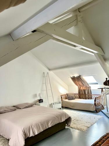 Ένα ή περισσότερα κρεβάτια σε δωμάτιο στο Loft atelier quatre