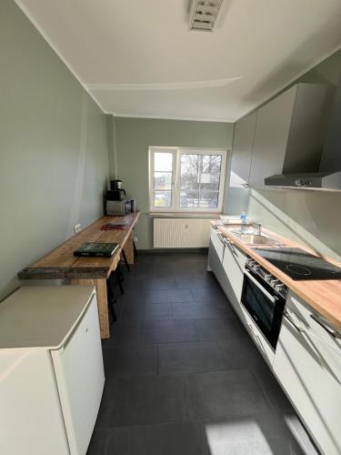 a kitchen with a table and a counter top at Bett4-you Pinneberg - Prisdorf in Prisdorf