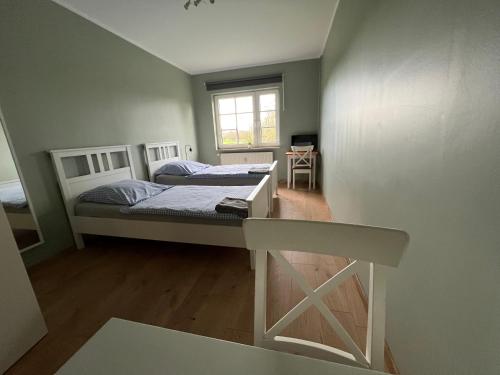 a small bedroom with two beds and a window at Bett4-you Pinneberg - Prisdorf in Prisdorf