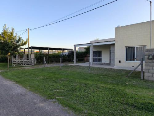 a building with a grass yard next to a building at Quintas Barceló in Baradero