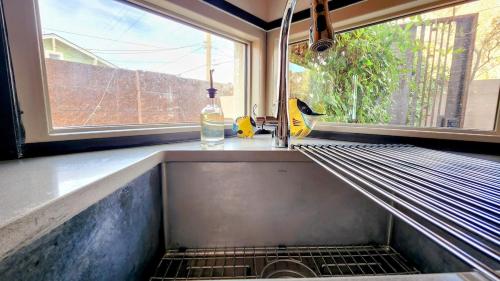 a sink in a kitchen with a window at Private Townhome Haven in Downtown in Albuquerque