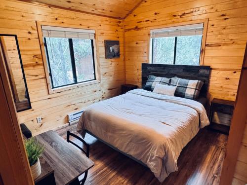 a bedroom with a bed in a log cabin at Pet Friendly Retreat in Rim Country! With a Spa! in Mogollon Airpark