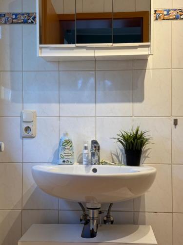 a white sink in a bathroom with a mirror at Bett4-you Pinneberg - Prisdorf in Prisdorf