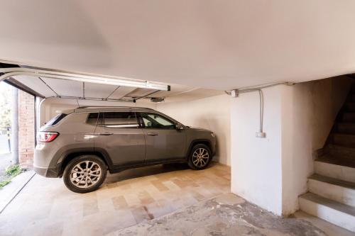 a car is parked in a garage at Casa Calise Elegant 1920s Villa with Garage in Siena