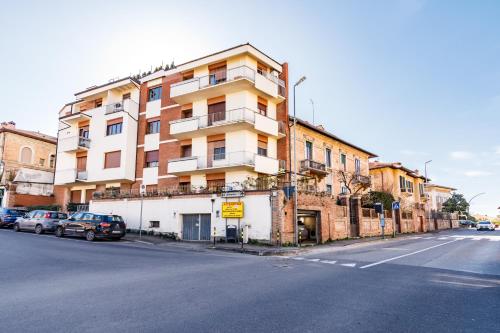 a building on the side of a street with parked cars at Casa Calise Elegant 1920s Villa with Garage in Siena