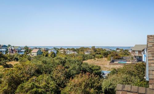 a view of a neighborhood with houses and the ocean at Sound Waves in Duck