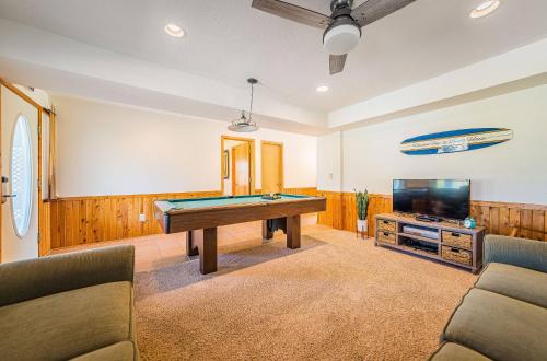 a room with a pool table and a flat screen tv at Sound Waves in Duck