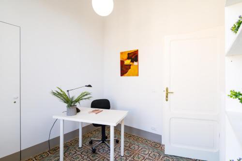 an office with a white desk and a chair at Casa Calise Elegant 1920s Villa with Garage in Siena