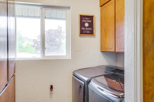 a kitchen with a refrigerator and a window at Spirit Lake Home with Fenced Yard 1 Mi to Water! in Spirit Lake
