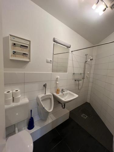 a bathroom with a toilet and a sink and a mirror at Bett4-you Pinneberg - Prisdorf in Prisdorf
