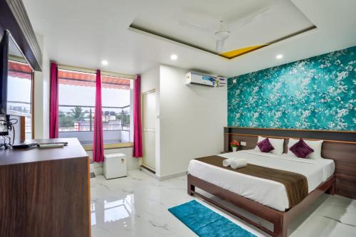 a bedroom with a bed and a desk in it at Antonios Calangute beach in Calangute