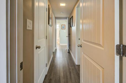 a hallway with white doors and wood floors at Dana Point Oceanfront Amazing Views STR14-0128 in Dana Point