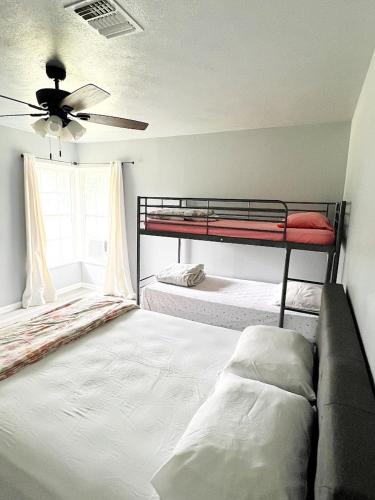 a bedroom with two bunk beds and a couch at Old Oak Ranch in Cameron