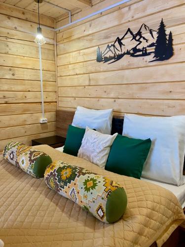 a bedroom with a bed with pillows at Водограй in Vorokhta