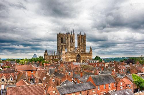 a view of a city with a cathedral and roofs at Tawny Barn in Lincoln