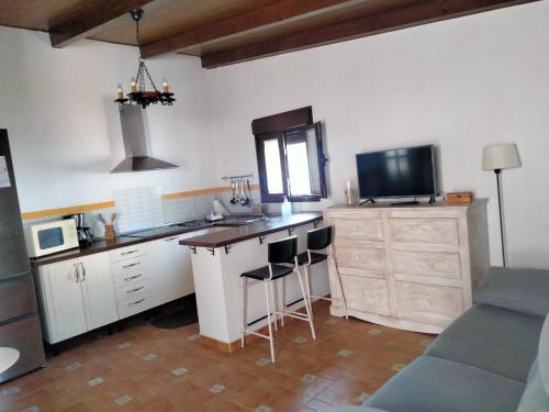 a kitchen with a counter with a sink and a tv at Chalet Islaterranova exclusivo para familias in Novo Sancti Petri