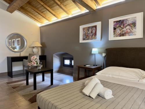 a bedroom with a bed and a table and a mirror at A Casa Mia - Catania Apartment in Catania