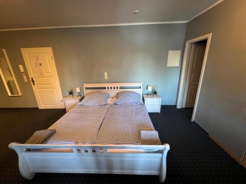 a bedroom with a large bed with a white frame at Bett4-you Pinneberg - Prisdorf in Prisdorf