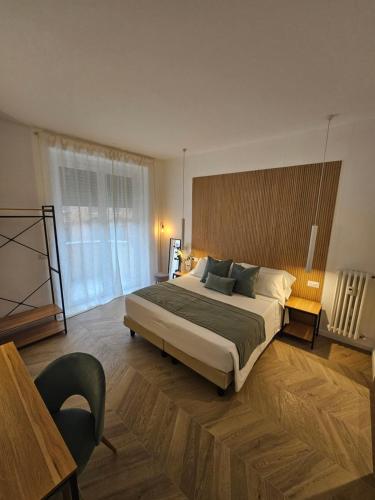 a bedroom with a large bed and a large window at Lilla Suites - Musei Vaticani in Rome