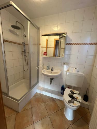 a bathroom with a toilet and a shower and a sink at Bett4-you Pinneberg - Prisdorf in Prisdorf