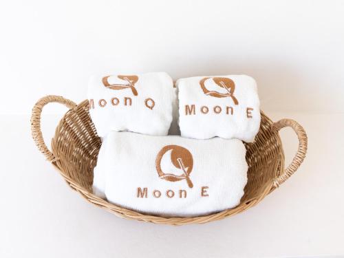 a basket of towels with the monogrammed towels at MoonE in Ban Karon
