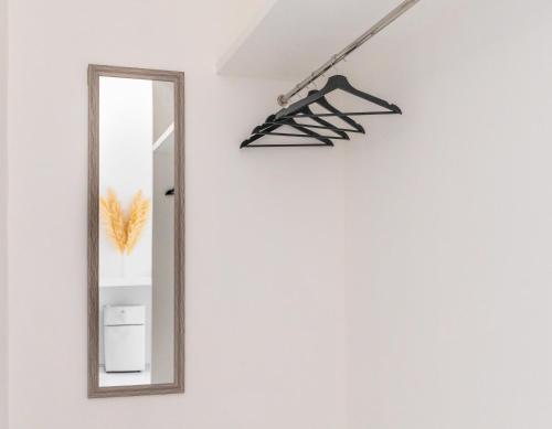a mirror on a wall next to a white wall at MoonE in Ban Karon